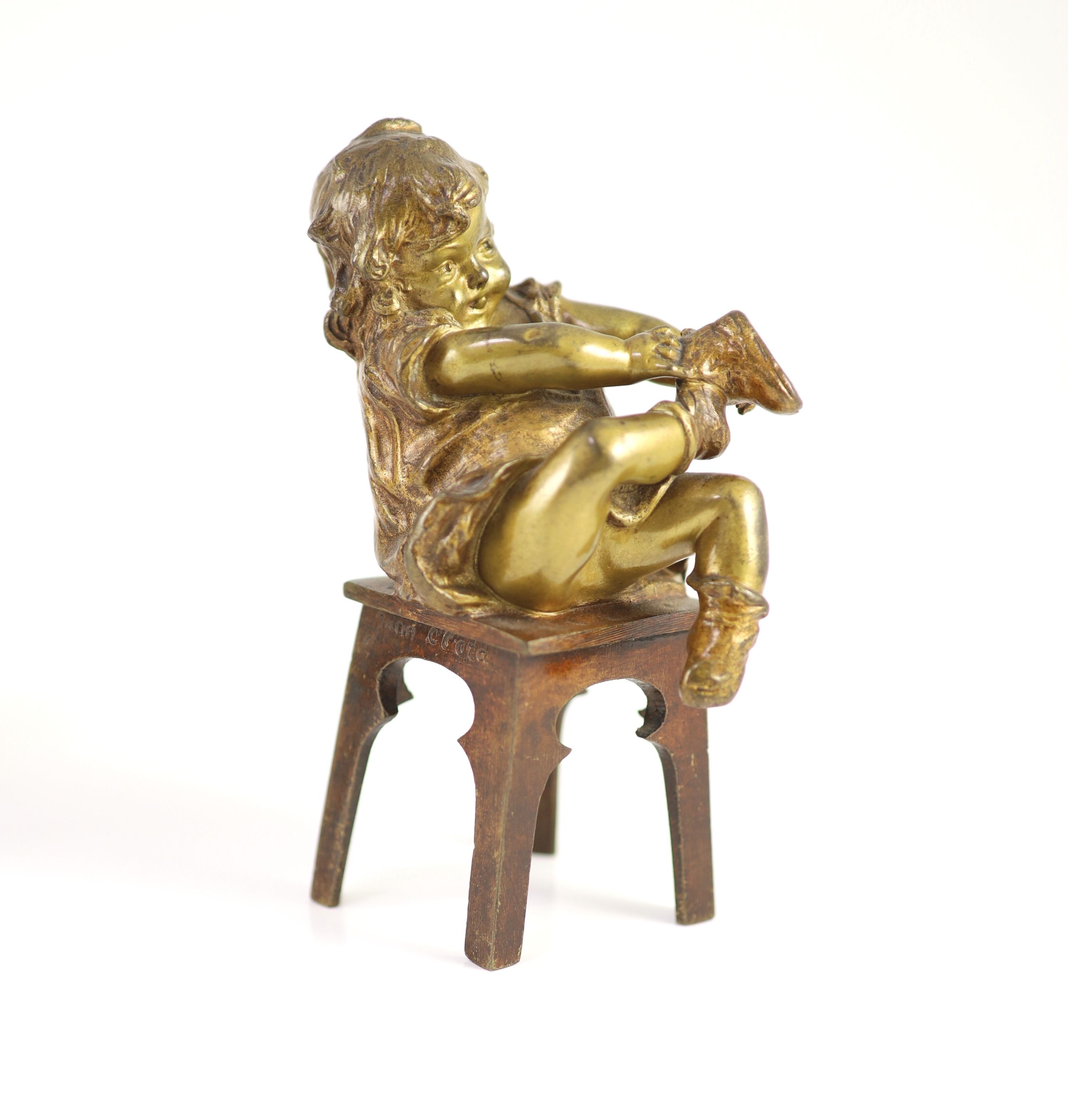 After Joan Clarà (1875 - 1958). A pair of bronze models of girls playing on chairs, height 15.5cm